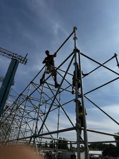 Climbing the scaffold against the sky