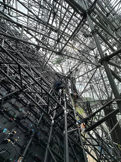 Inside the steel structure behind the screen
