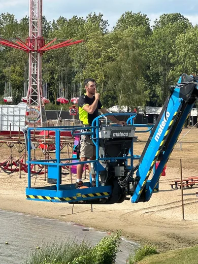 Working from a boom lift by the lake