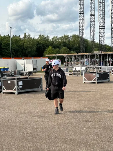 Crew crossing the backstage yard